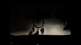 Going down to an underground copper mine in a truck, the car hangs a dream catcher