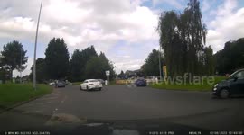 Car drive recklessly enters roundabout without looking causing me to brake hard.