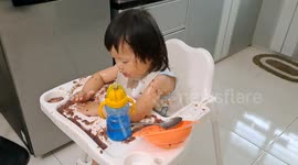 One Year Old Girl from Malaysia Eating in a Mess