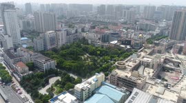 Drone descending slowly from above to shoot Changzhou City People's Park.