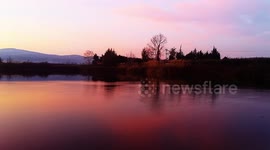 Stunning sunset over a lake with relaxing nature sounds
