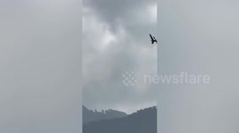 Helicopter battles to reach six children and two adult stuck in cable car in Pakistan