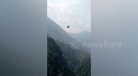 Six children and two adults trapped in cable car 900ft above ground in Pakistan