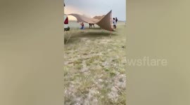 Campers battle to pitch tents during storm in Thailand