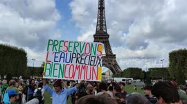 The Water Convoy (in french: Le Convoi de l'Eau) arrives in Paris, Eiffel Tower, France.  Ecologist gathering against the mega-basins. By Greenpeace, Les Soulèvement de la Terre and other, 26 aug 2023.