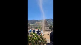 Tourists stunned as dust devils sweep through temple site in Indonesia