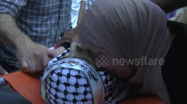 Palestinians carry the body of Ezzelddin Kanaan, 20, who was died after he succumbed to his injuries sustained, during his funeral in the town of Jaba' in the West Bank city of Jenin