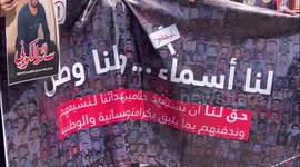 Palestinian protesters stand by mock coffins covered with the Palestinian flag as they demand the return of the bodies of their slain relatives held by Israeli forces, during a rally in Nablus city in the West Bank