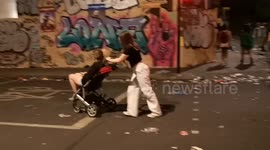 Some rather merry people pushing their friend in a pushchair as the Notting Hill Carnival winds down
