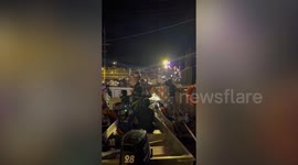 Revellers plunge into water when speedboat sinks during concert at floating market in Thailand