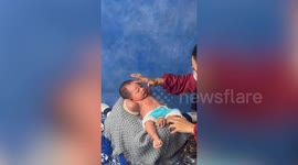 Baby looks seriously unhappy while posing for portrait