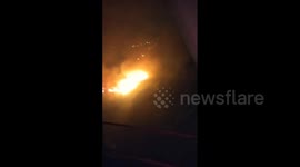 Large forest fire in Ecuador seen from elevated bridge
