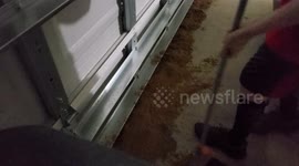 Using Sand to seal up a garage interior from the rising flood waters of Hurricane / tropical storm Ophelia