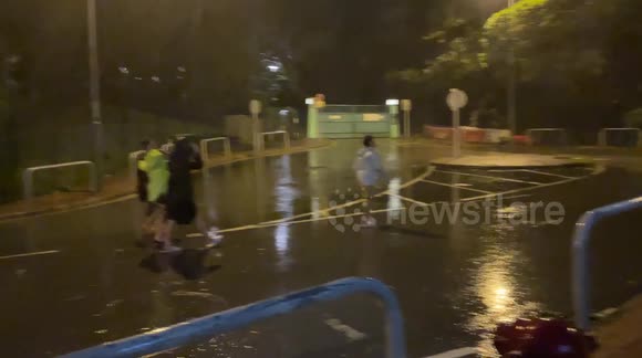 Strong winds by the side of a building create mini tornado as Super-Typhoon Saola makes landfall