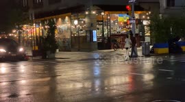East Village summer night street scene with car traffic, bicycles, cabs, pedestrians