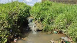 Small water fall gushing out from a water drainage