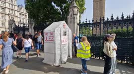 Man wanders around wearing a mobile greenhouse during ULEZ protest outside Houses of Parliament