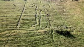 Long Man of Wilmington given a trim by volunteers as UK experiences heatwave