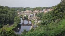 People enjoy hot weather in rowing boats underneath the Knaresborough Viaduct in UK