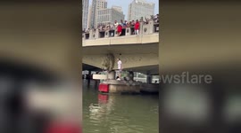 Embarrassed daredevil's WIG flies off when he jumps into river in China
