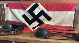 Police called after auctioneer hoists Nazi swastika flag in shop window to promote WW2 auction