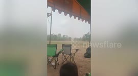 Dust devil tornado whips through field during school sports day