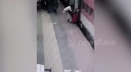 Passenger slips while trying to board moving train in eastern India, cop comes to rescue