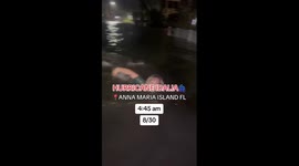 Woman SWIMS through flooded street after hurricane Idalia hits Florida Part 1/5