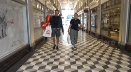 Visitors leaving The Art of Banksy Regent Street exhibition with heart balloons