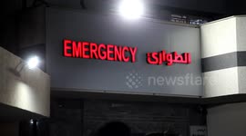 Palestinians carry the bodies of men killed during an explosion near the border fence with Israel