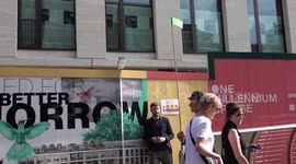 People queue across the Millennium Bridge for the climate strike in London, UK
