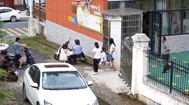 Heroic Chinese police sprints to cushion falling electric scooter as girl climbs aboard