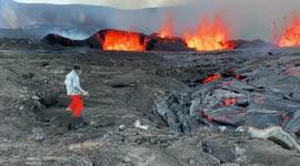 Scientist Shovels Molten Lava Into A Bucket To Carry It Away For Testing At Kilauea Summit In Hawaii, USA