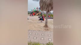 Thai policeman sways on spring rider like it is mechanical bull rodeo