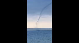 Waterspout with perfect pipe on Lake Ontario including a close up shot of the swirling mist field.