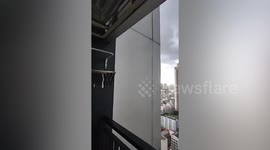 Building wall panels rattle during storm in Bangkok