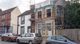 Fuming builder puts stone gargoyle of local official on his roof as planning row turns ugly