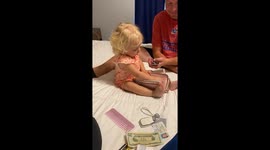 Cute toddler tries her hand at reading the cards in her dad's wallet *Cute Video*