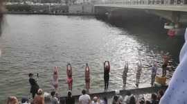 Seven swimmers perform synchronised dive into Chinese river