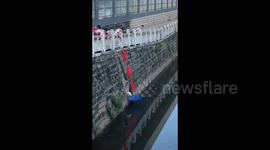 Chinese Child Uses Red Scarf as a Lifeline to Rescue a Kitten that Trapped in Hole in River Bank in Sichuan, China