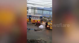 Pedestrians fall into uncovered hole during floods in the Philippines