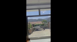 Chinese man standing on a wall uses three-wheeled motorbike as DIY ab roller