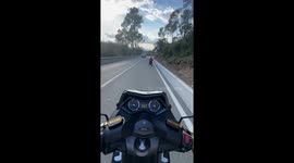Motorcycle Follows Wheelchair Down Hill
