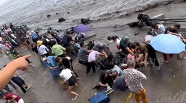 Spectators injured and nearly flushed away amid surging tides in China