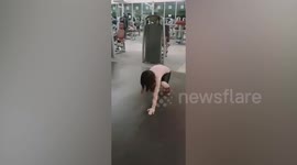 Inspiring girl with no right hand exercises in gym