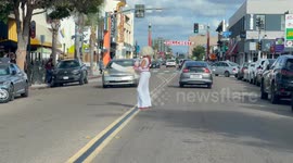Stopping Traffic Halloween bride dancing in the street to show what’s under the wig
