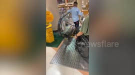 Lad with paralysed legs show how to safely ride escalator on wheelchair