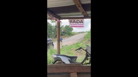 Grandfather peddles push bike with tiny wheels up steep hill