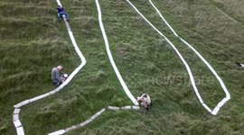 The Long Man of Wilmington gets a lick of paint (once every 5 years), Wilmington, East Sussex, UK