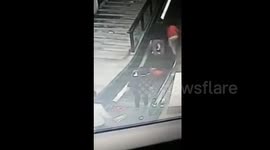 Man saves the day after woman and child fall over on escalator